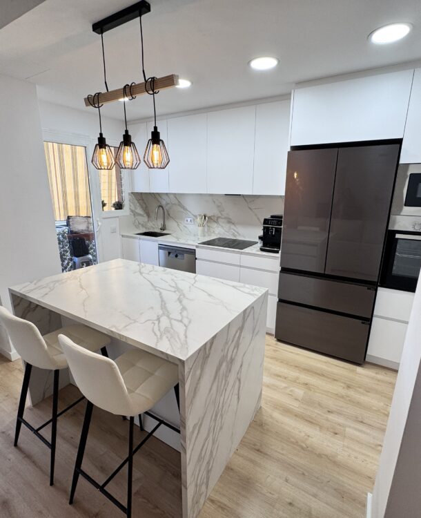 Descubre cómo transformamos una vivienda en Sant Vicenç dels Horts eliminando barreras arquitectónicas. Un proyecto de Grup Innova que integra una isla de porcelánico Neolith, mobiliario a medida y suelo laminado de alta resistencia en un espacio unificado y lleno de luz.