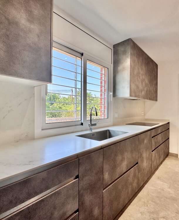 Descubre esta reforma de cocina en Caldes de Montbui con mobiliario a medida, suelo porcelánico Pamesa, encimera Dekton y acabados de alta calidad.